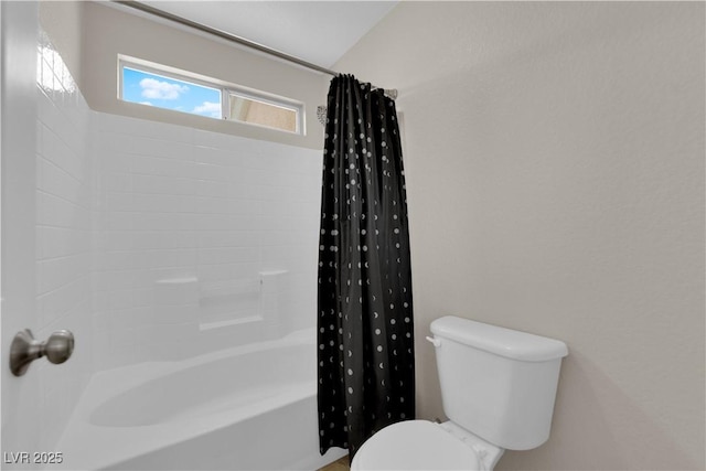 full bathroom featuring toilet and shower / bath combo with shower curtain
