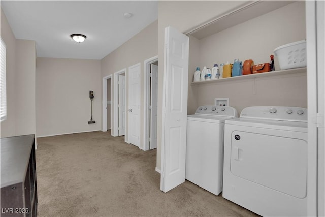 laundry area with light carpet, laundry area, and washing machine and dryer