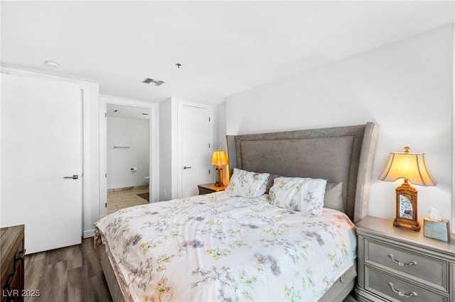 bedroom with visible vents and wood finished floors