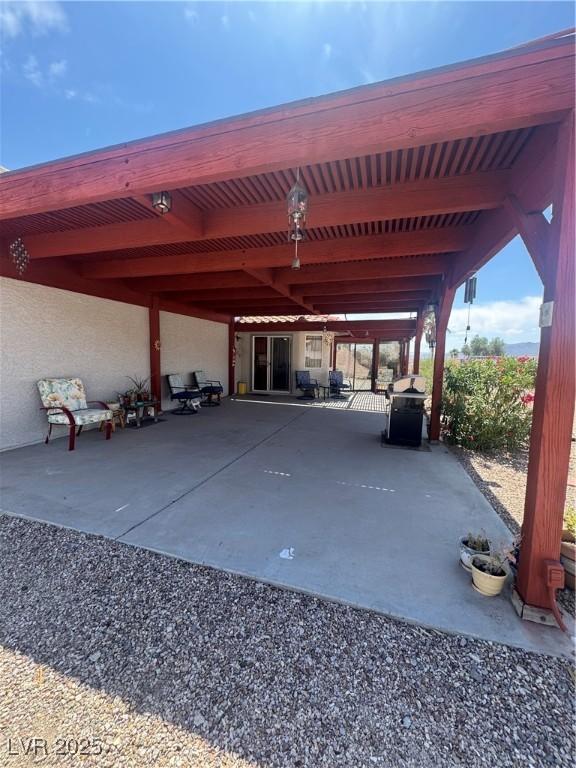 view of parking / parking lot featuring a carport