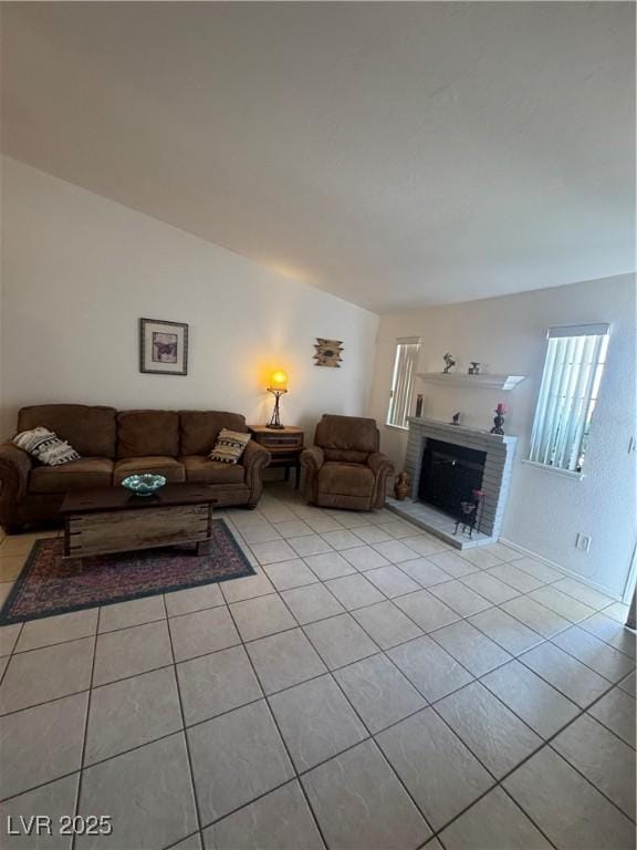 tiled living area with a brick fireplace