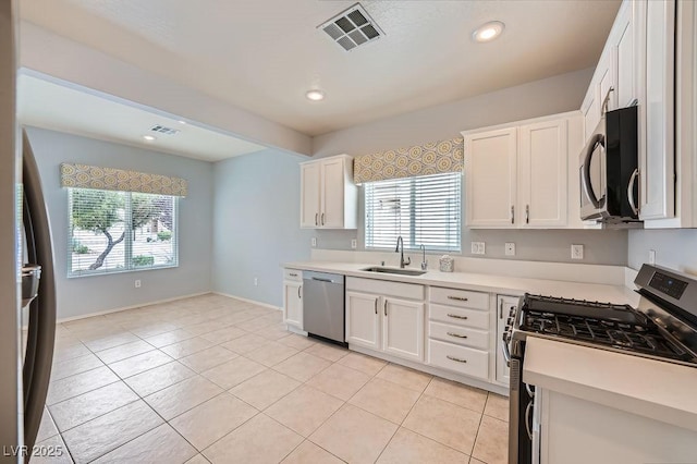 kitchen featuring a sink, a healthy amount of sunlight, visible vents, and appliances with stainless steel finishes