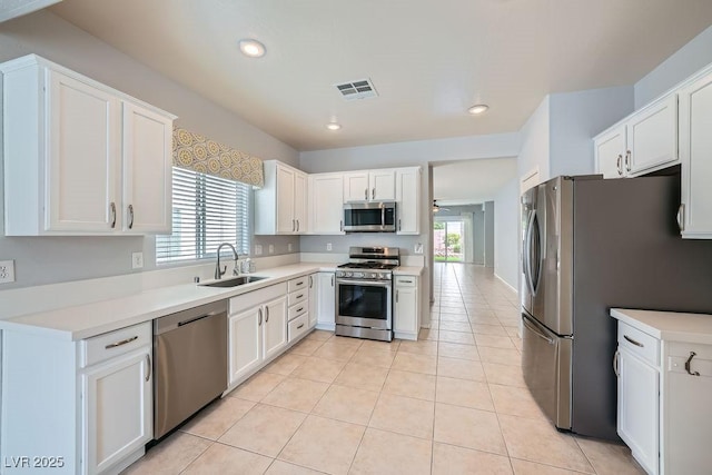 kitchen featuring a sink, stainless steel appliances, recessed lighting, ceiling fan, and white cabinets