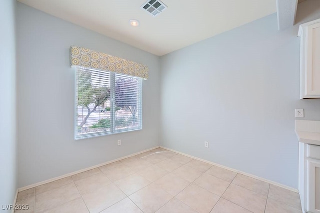 unfurnished dining area with visible vents, baseboards, and light tile patterned flooring