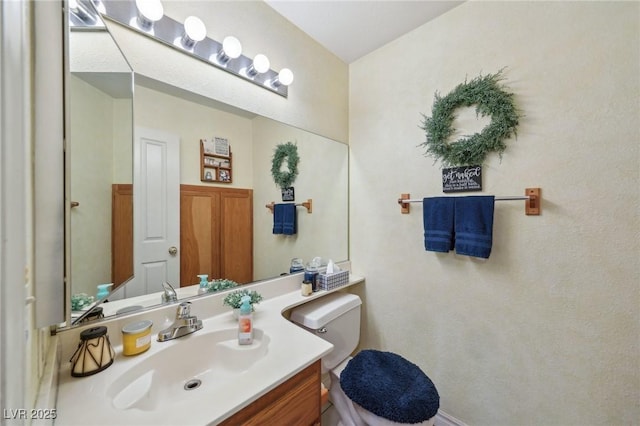 bathroom with toilet and vanity