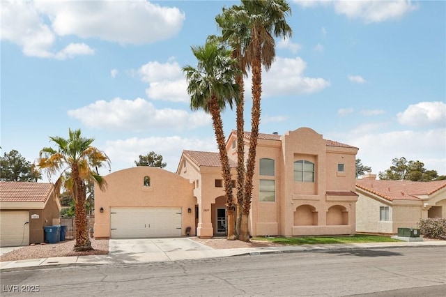 view of front of house featuring stucco siding, a garage, concrete driveway, and a tiled roof