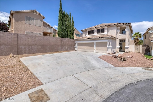 exterior space with an attached garage, a tiled roof, stucco siding, fence, and driveway
