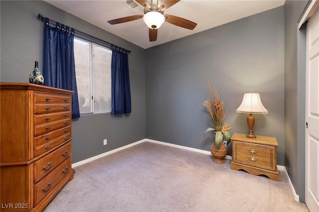bedroom with baseboards, light carpet, visible vents, and ceiling fan