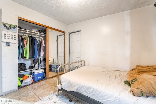 1708 Weeping Willow Ln, Las Vegas, NV 89104 - bedroom featuring a textured ceiling, light tile patterned flooring, and a closet