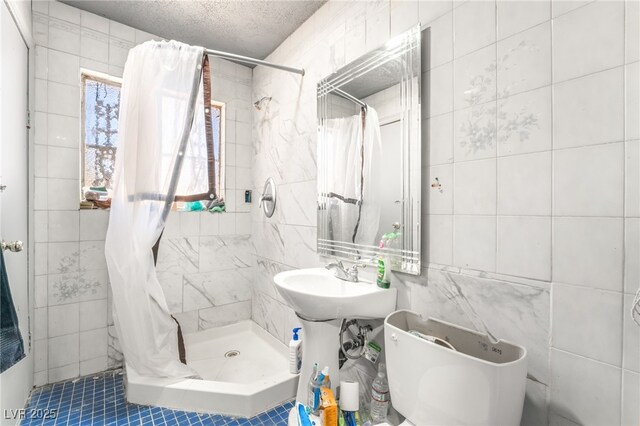 1708 Weeping Willow Ln, Las Vegas, NV 89104 - bathroom featuring tile walls, a stall shower, and tile patterned flooring