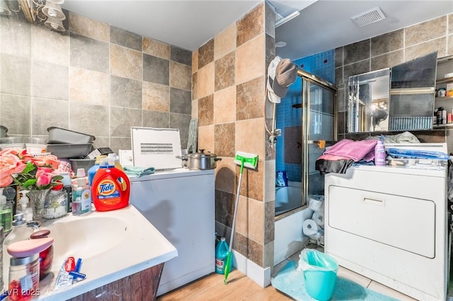 1708 Weeping Willow Ln, Las Vegas, NV 89104 - full bathroom with tile walls, shower / bath combination with glass door, washer / dryer, and a sink