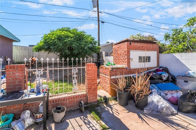 1708 Weeping Willow Ln, Las Vegas, NV 89104 - view of patio with a fenced backyard, a storage shed, and an outbuilding
