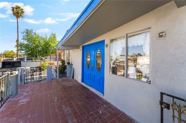 1708 Weeping Willow Ln, Las Vegas, NV 89104 - doorway to property featuring stucco siding and fence