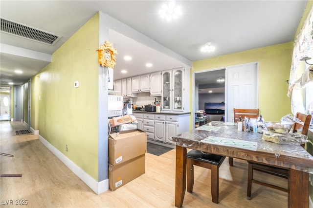 1708 Weeping Willow Ln, Las Vegas, NV 89104 - kitchen featuring light wood-style floors, baseboards, glass insert cabinets, white cabinets, and recessed lighting