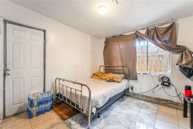 1708 Weeping Willow Ln, Las Vegas, NV 89104 - tiled bedroom featuring a textured ceiling
