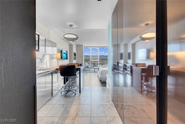 interior space with floor to ceiling windows and a sink