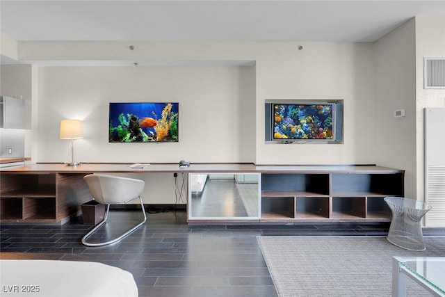 unfurnished living room featuring visible vents and wood finished floors