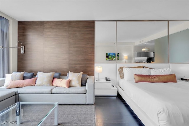 bedroom with dark wood-style flooring