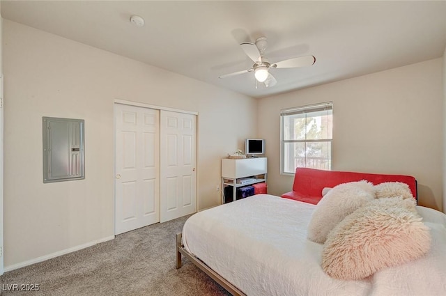 bedroom with carpet, a ceiling fan, a closet, electric panel, and baseboards