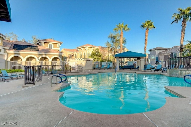 pool with fence and a patio