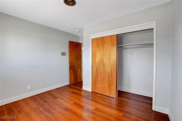 819 Bracken Ave, Las Vegas, NV 89104 - unfurnished bedroom featuring a closet, baseboards, and wood finished floors