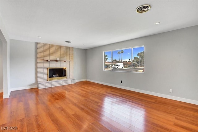 819 Bracken Ave, Las Vegas, NV 89104 - unfurnished living room featuring baseboards, visible vents, and wood finished floors