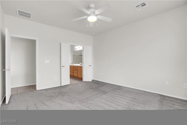 unfurnished bedroom featuring baseboards, visible vents, and carpet