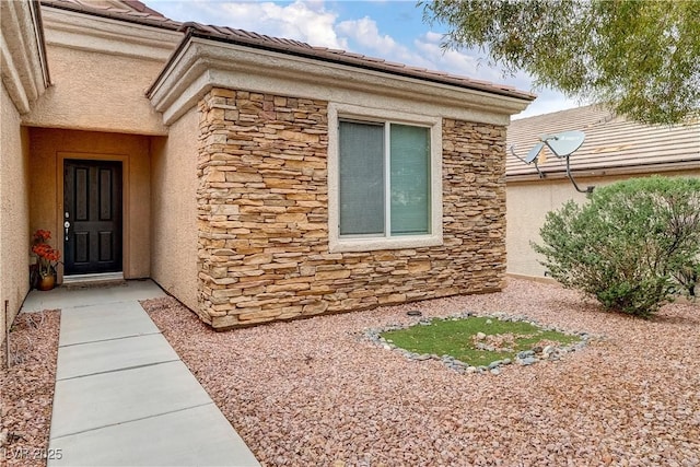 entrance to property with stucco siding and stone siding