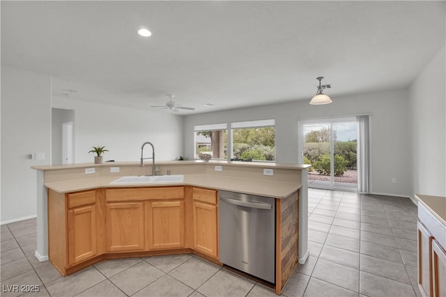 kitchen with a sink, ceiling fan, light countertops, light tile patterned floors, and stainless steel dishwasher