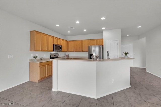 kitchen featuring light tile patterned floors, light countertops, stainless steel appliances, and recessed lighting