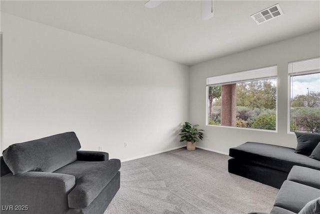 interior space featuring ceiling fan, carpet, baseboards, and visible vents