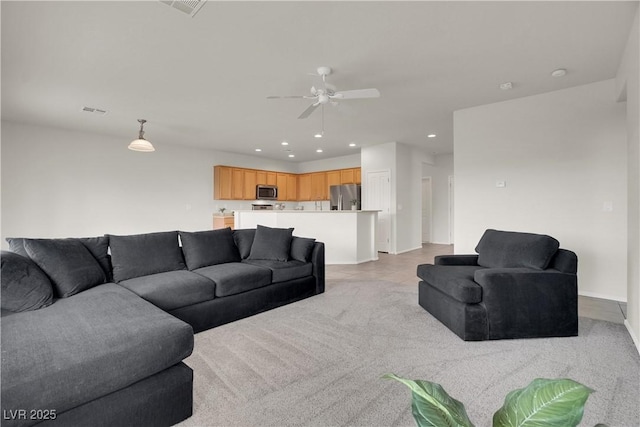 living area with ceiling fan, baseboards, visible vents, and recessed lighting