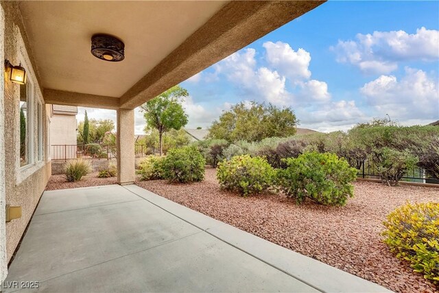 view of patio / terrace with a wall unit AC and fence