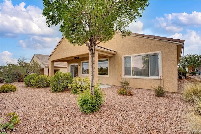 back of house with stucco siding