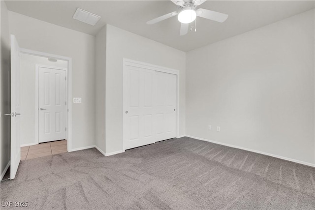 unfurnished bedroom with carpet flooring, baseboards, a ceiling fan, and visible vents