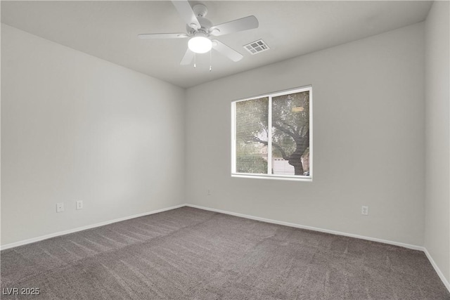 carpeted empty room featuring ceiling fan, baseboards, and visible vents