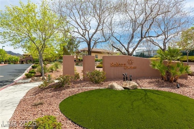 community / neighborhood sign with a lawn