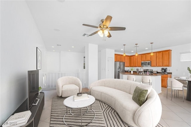 living area with ceiling fan, light tile patterned flooring, and recessed lighting