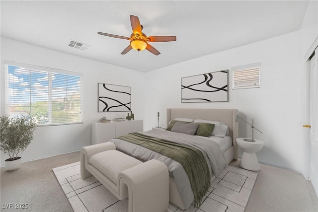 bedroom with light colored carpet, baseboards, and ceiling fan
