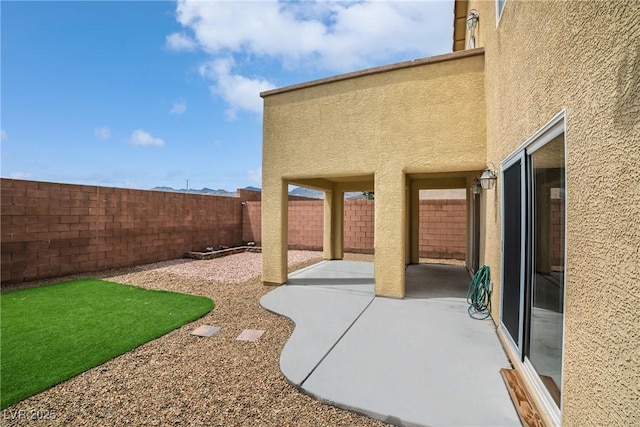fenced backyard with a patio