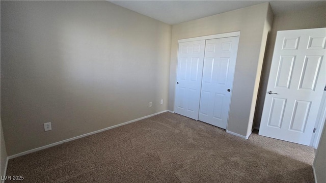 unfurnished bedroom featuring baseboards, a closet, and carpet floors