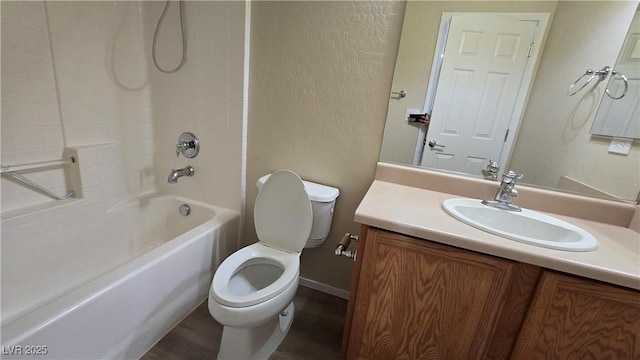 full bath featuring toilet, shower / bathing tub combination, wood finished floors, and vanity
