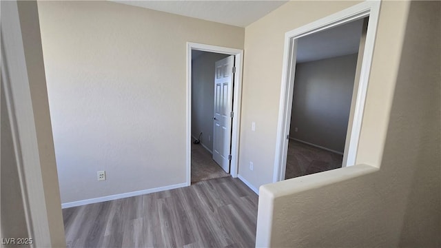 interior space with baseboards and wood finished floors