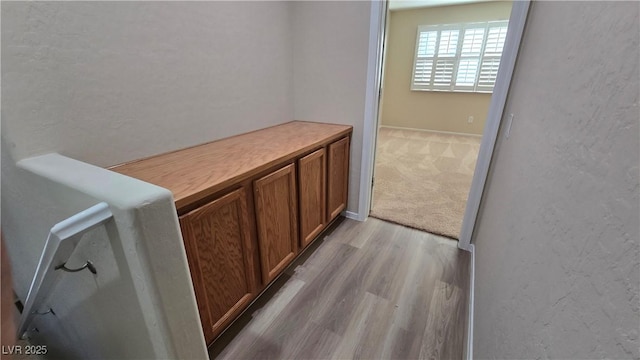 corridor featuring wood finished floors