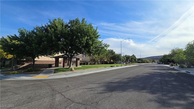 view of street with street lighting, curbs, and sidewalks