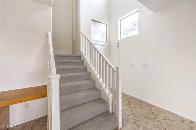 stairs featuring tile patterned floors
