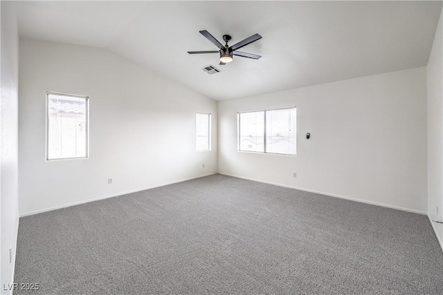 spare room with a ceiling fan, carpet, lofted ceiling, and plenty of natural light