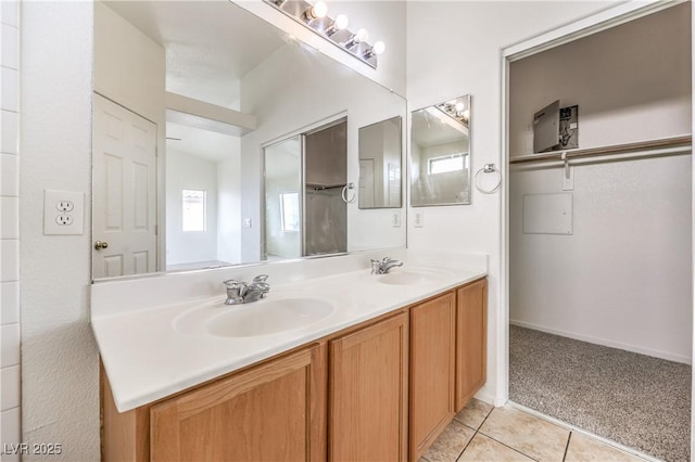bathroom featuring a sink, double vanity, and tile patterned floors
