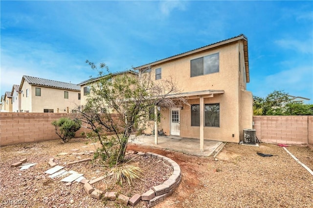 back of house featuring a fenced backyard, a patio, stucco siding, and cooling unit