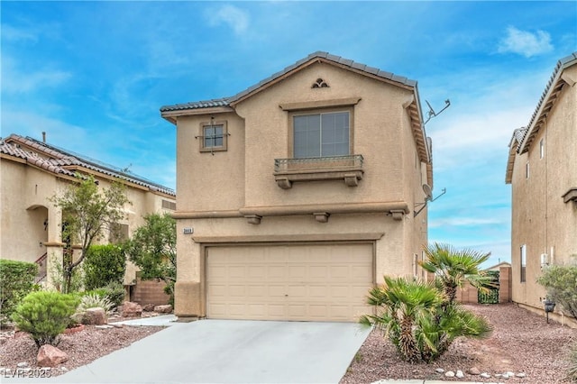 mediterranean / spanish-style house featuring concrete driveway, stucco siding, and an attached garage